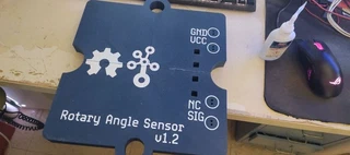 The back of the assembled base plate, showing the Rotary Angle Sensor v1.2 label, the logo, and the GND/VCC/NC/SIG pin labels.