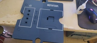 The fully assembled base plate, front side, showing the J1 connector silkscreen and the ROTATION label around the central cutout.