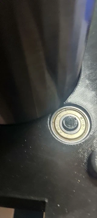 Close-up of one bearing seated in its well, marked 608Z / ABEC5.