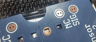 The SIG and NC pads: SIG has a wire threaded through and touching the copper, NC is just taped over with no wire.