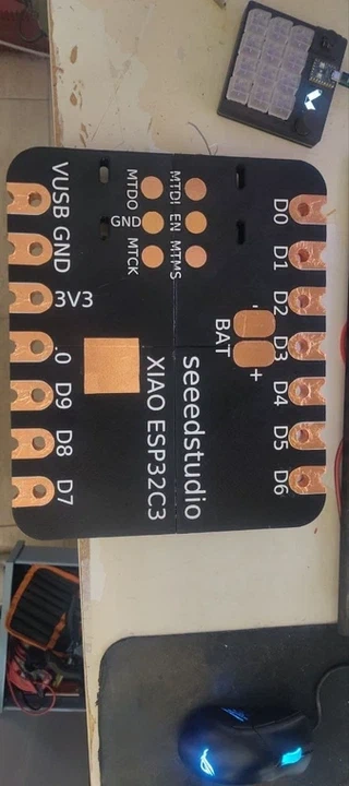 The front face of the giant XIAO, showing all pin labels (D0-D9, 3V3, GND, VUSB, BAT, MTDI, EN, MTMS&mldr;) with copper tape pads at each position.