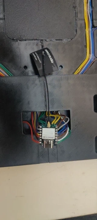 The real XIAO ESP32-C3 soldered with all its wires inside the USB-C port cavity, seen from the bottom of the board.