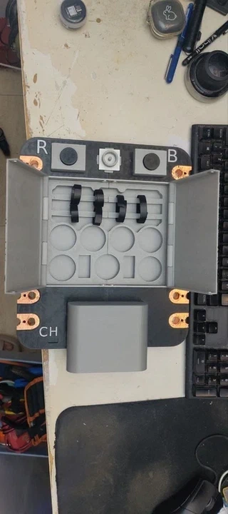 The organizer tray installed, showing circular wells holding small modules (XIAO boards, Grove sensors) and top rails with velcro cable ties holding jumper wires.
