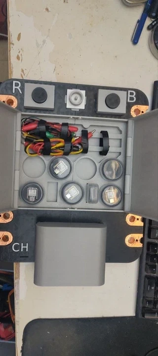 The tray fully loaded: jumper wires and crocodile clip cables secured with velcro, small XIAO-compatible boards and sensor modules in the circular wells.