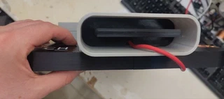 A real USB-C cable plugged into the giant port, reaching the XIAO&rsquo;s actual USB-C connector.